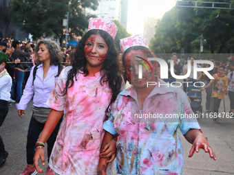 People in disguise take part in the annual Zombie Walk 2024 from the Monument to the Revolution to the main square Zocalo in Mexico City, Me...