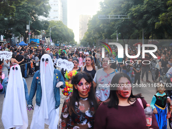 People in disguise take part in the annual Zombie Walk 2024 from the Monument to the Revolution to the main square Zocalo in Mexico City, Me...