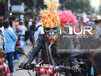 A person in disguise takes part in the annual Zombie walk from the Monument to the Revolution to the main square Zocalo in Mexico City, Mexi...