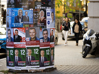 People walk past pre-election posters of parties and coalitions in Sofia, Bulgaria, on October 16, 2024. Bulgaria holds an early parliamenta...