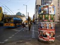 People walk past pre-election posters of parties and coalitions in Sofia, Bulgaria, on October 16, 2024. Bulgaria holds an early parliamenta...