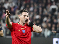 Referee Juan Luca Sacchi listens to the VAR during the Serie A football match number 8, Juventus vs. Lazio, at the Allianz Stadium in Turin,...