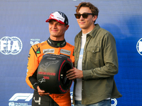 Lando Norris of the UK drives the McLaren F1 Team MCL38 Mercedes, and Armand Duplantis is present during the qualifying for the Formula 1 Pi...