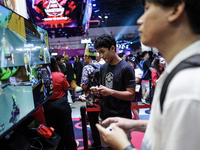 Gamers play video games with the Nintendo Switch at the Thailand Game Show 2024 in Bangkok, Thailand, on October 20, 2024. The Thailand Game...