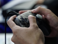 A gamer uses a controller to play a Sony PlayStation 5 game at the Thailand Game Show 2024 in Bangkok, Thailand, on October 20, 2024. The Th...