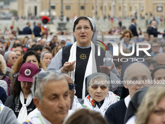 A nun prays during the Holy Mass and canonization of 14 saints and martyrs from Damascus, at Saint Peter's Square in the Vatican, on October...