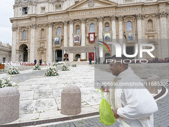 A priest runs in front of the churchyard before the start of the Holy Mass and canonization of 14 saints and martyrs from Damascus, at Saint...