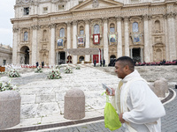 A priest runs in front of the churchyard before the start of the Holy Mass and canonization of 14 saints and martyrs from Damascus, at Saint...