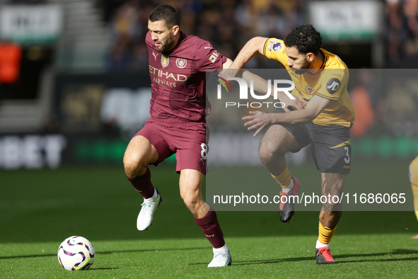 Mateo Kovacic of Manchester City and Rayan Ait-Nouri of Wolves are in action during the Premier League match between Wolverhampton Wanderers...