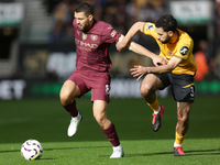 Mateo Kovacic of Manchester City and Rayan Ait-Nouri of Wolves are in action during the Premier League match between Wolverhampton Wanderers...