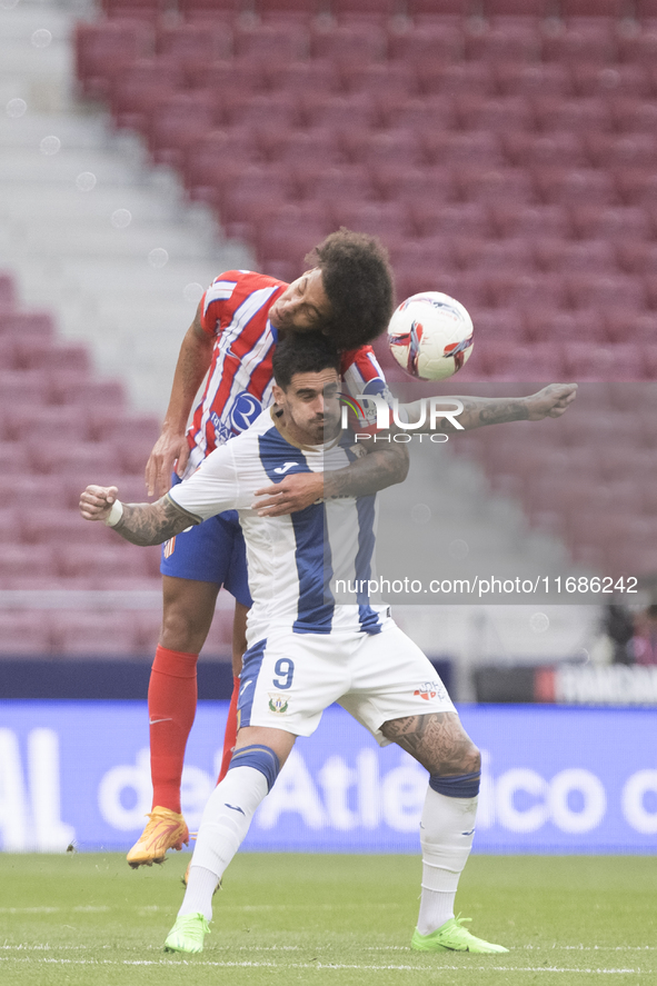 Axel Witsel of Atletico de Madrid and Miguel de la Fuente of Leganes fight for the ball during the La Liga 2024/25 match between Atletico de...