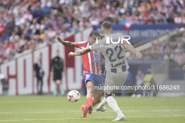 Angel Correa of Atletico de Madrid and Matija Nastasic of Leganes fight for the ball during the La Liga 2024/25 match between Atletico de Ma...