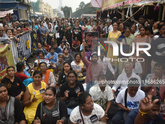 Citizens shout slogans while they attend the Junior Doctors hunger strike to protest the rape and murder case of a medic in a government-run...