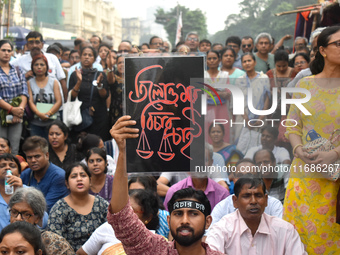 Citizens shout slogans while they attend the Junior Doctors hunger strike to protest the rape and murder case of a medic in a government-run...