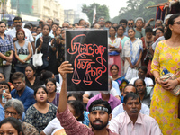 Citizens shout slogans while they attend the Junior Doctors hunger strike to protest the rape and murder case of a medic in a government-run...