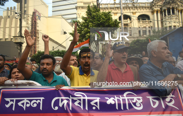 Citizens shout slogans while they attend the Junior Doctors hunger strike to protest the rape and murder case of a medic in a government-run...