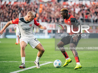 Victor Boniface of Bayer 04 Leverkusen plays against Rasmus Kristensen of Eintracht Frankfurt during the Bundesliga match between Bayer 04 L...