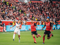 Omar Marmoush of Eintracht Frankfurt plays against Piero Hincapie and Jonathan Tah of Bayer 04 Leverkusen during the Bundesliga match betwee...