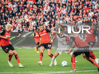 Omar Marmoush of Eintracht Frankfurt plays against Jonathan Tah, Edmond Tapsoba, Granit Xhaka, and Robert Andrich of Bayer 04 Leverkusen dur...