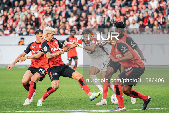 Omar Marmoush of Eintracht Frankfurt plays against Jonathan Tah, Edmond Tapsoba, Granit Xhaka, and Robert Andrich of Bayer 04 Leverkusen dur...