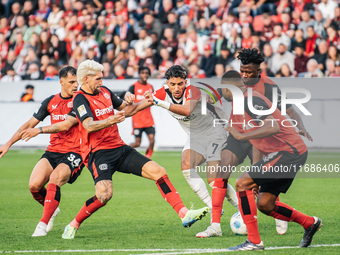 Omar Marmoush of Eintracht Frankfurt plays against Jonathan Tah, Edmond Tapsoba, Granit Xhaka, and Robert Andrich of Bayer 04 Leverkusen dur...