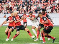 Omar Marmoush of Eintracht Frankfurt plays against Jonathan Tah, Edmond Tapsoba, Granit Xhaka, and Robert Andrich of Bayer 04 Leverkusen dur...