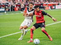 Omar Marmoush of Eintracht Frankfurt plays against Piero Hincapie of Bayer 04 Leverkusen during the Bundesliga match between Bayer 04 Leverk...