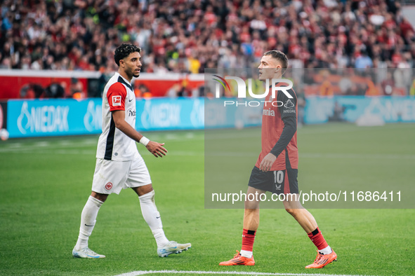 Omar Marmoush of Eintracht Frankfurt and Florian Wirtz of Bayer 04 Leverkusen appear during the Bundesliga match between Bayer 04 Leverkusen...