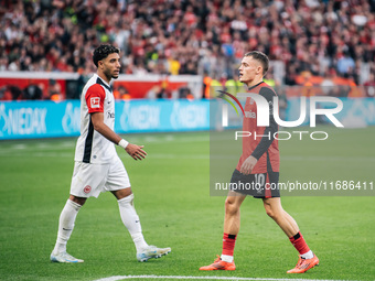 Omar Marmoush of Eintracht Frankfurt and Florian Wirtz of Bayer 04 Leverkusen appear during the Bundesliga match between Bayer 04 Leverkusen...