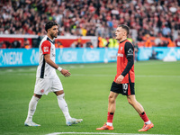 Omar Marmoush of Eintracht Frankfurt and Florian Wirtz of Bayer 04 Leverkusen appear during the Bundesliga match between Bayer 04 Leverkusen...