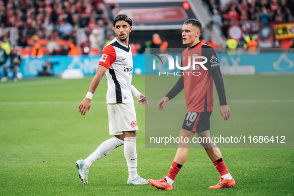 Omar Marmoush of Eintracht Frankfurt and Florian Wirtz of Bayer 04 Leverkusen appear during the Bundesliga match between Bayer 04 Leverkusen...