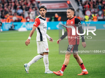 Omar Marmoush of Eintracht Frankfurt and Florian Wirtz of Bayer 04 Leverkusen appear during the Bundesliga match between Bayer 04 Leverkusen...