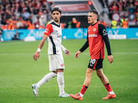 Omar Marmoush of Eintracht Frankfurt and Florian Wirtz of Bayer 04 Leverkusen appear during the Bundesliga match between Bayer 04 Leverkusen...