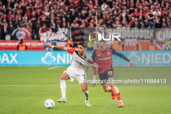 Omar Marmoush of Eintracht Frankfurt plays against Florian Wirtz of Bayer 04 Leverkusen during the Bundesliga match between Bayer 04 Leverku...