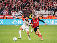 Omar Marmoush of Eintracht Frankfurt plays against Florian Wirtz of Bayer 04 Leverkusen during the Bundesliga match between Bayer 04 Leverku...