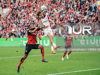 Hugo Ekitike of Eintracht Frankfurt plays against Jonathan Tah of Bayer 04 Leverkusen during the Bundesliga match between Bayer 04 Leverkuse...