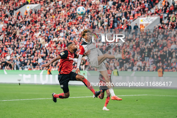 Hugo Ekitike of Eintracht Frankfurt plays against Jonathan Tah of Bayer 04 Leverkusen during the Bundesliga match between Bayer 04 Leverkuse...