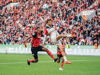 Hugo Ekitike of Eintracht Frankfurt plays against Jonathan Tah of Bayer 04 Leverkusen during the Bundesliga match between Bayer 04 Leverkuse...