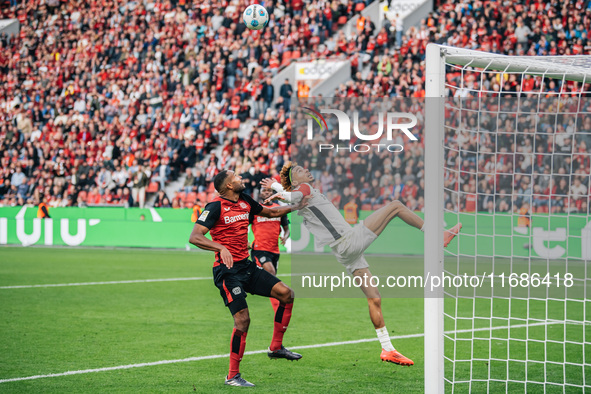 Hugo Ekitike of Eintracht Frankfurt plays against Jonathan Tah of Bayer 04 Leverkusen during the Bundesliga match between Bayer 04 Leverkuse...