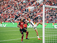 Hugo Ekitike of Eintracht Frankfurt plays against Jonathan Tah of Bayer 04 Leverkusen during the Bundesliga match between Bayer 04 Leverkuse...