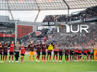 Players of Bayer 04 Leverkusen celebrate with fans after the Bundesliga match between Bayer 04 Leverkusen and Eintracht Frankfurt at BayAren...