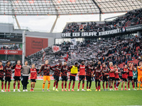 Players of Bayer 04 Leverkusen celebrate with fans after the Bundesliga match between Bayer 04 Leverkusen and Eintracht Frankfurt at BayAren...