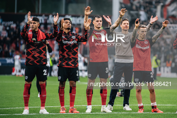 Xabi Alonso, Head Coach of Bayer 04 Leverkusen, and his players celebrate with fans after the Bundesliga match between Bayer 04 Leverkusen a...