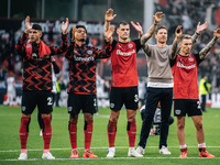 Xabi Alonso, Head Coach of Bayer 04 Leverkusen, and his players celebrate with fans after the Bundesliga match between Bayer 04 Leverkusen a...