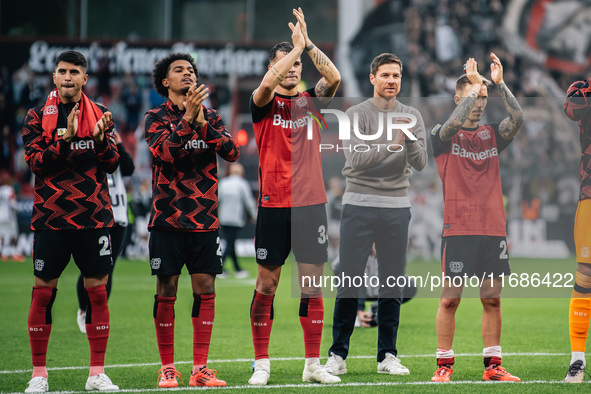 Xabi Alonso, Head Coach of Bayer 04 Leverkusen, and his players celebrate with fans after the Bundesliga match between Bayer 04 Leverkusen a...