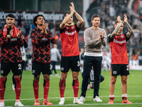 Xabi Alonso, Head Coach of Bayer 04 Leverkusen, and his players celebrate with fans after the Bundesliga match between Bayer 04 Leverkusen a...