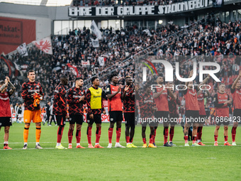 Players of Bayer 04 Leverkusen celebrate with fans after the Bundesliga match between Bayer 04 Leverkusen and Eintracht Frankfurt at BayAren...