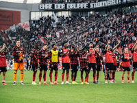 Players of Bayer 04 Leverkusen celebrate with fans after the Bundesliga match between Bayer 04 Leverkusen and Eintracht Frankfurt at BayAren...