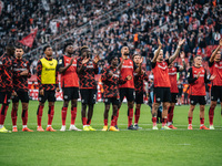 Players of Bayer 04 Leverkusen celebrate with fans after the Bundesliga match between Bayer 04 Leverkusen and Eintracht Frankfurt at BayAren...