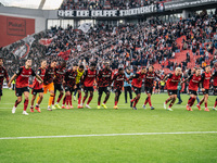 Players of Bayer 04 Leverkusen celebrate with fans after the Bundesliga match between Bayer 04 Leverkusen and Eintracht Frankfurt at BayAren...